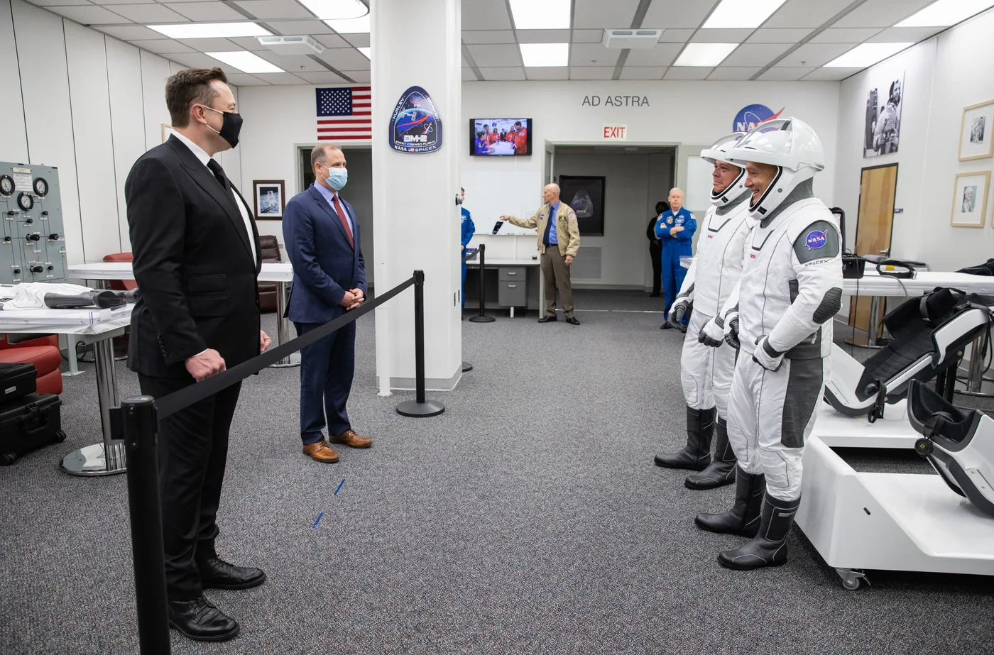 Elon Musk and NASA officials speaking with suited Demo-2 astronauts in May 2020