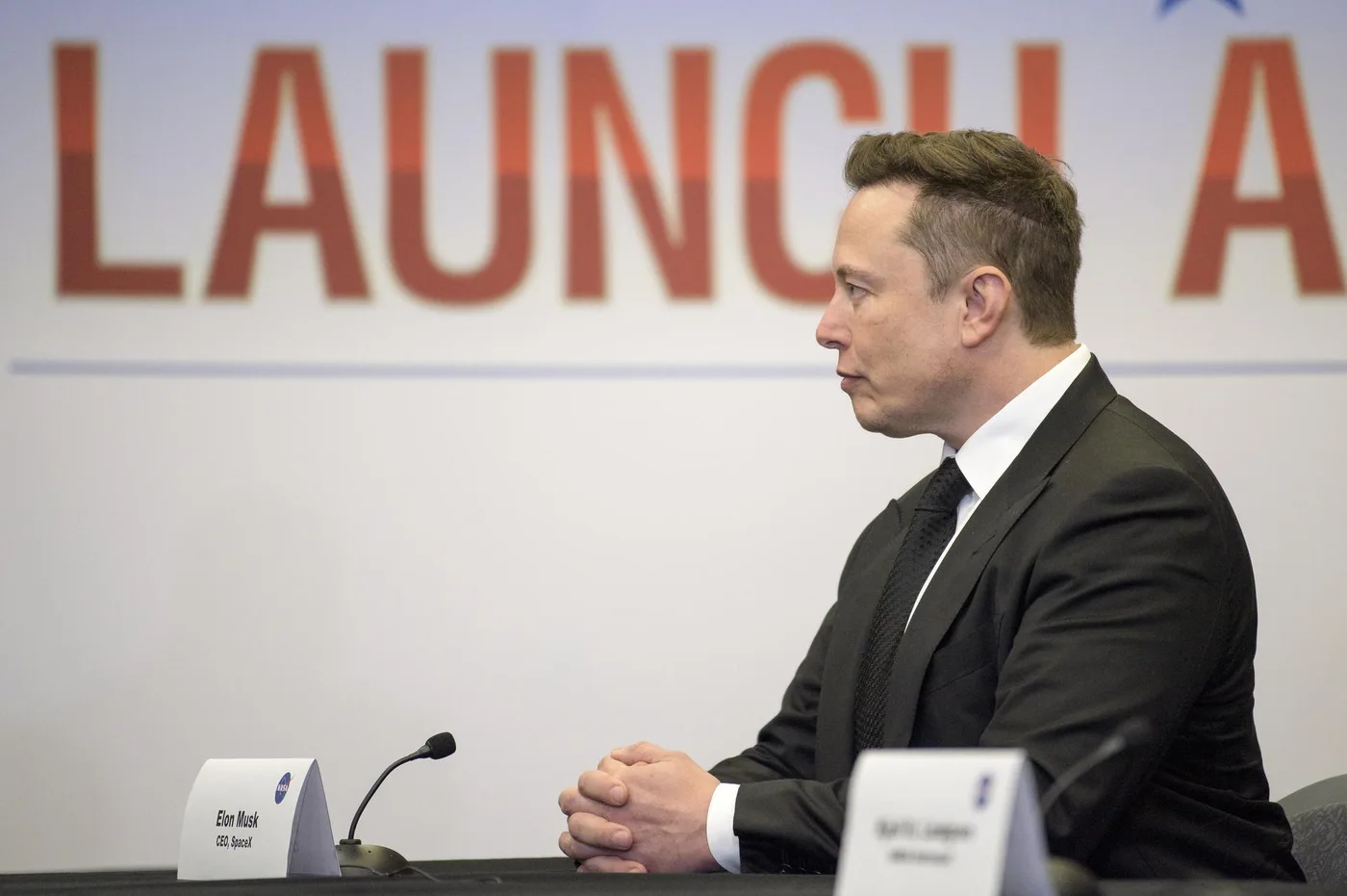 Elon Musk seated at a NASA mission briefing in May 2020