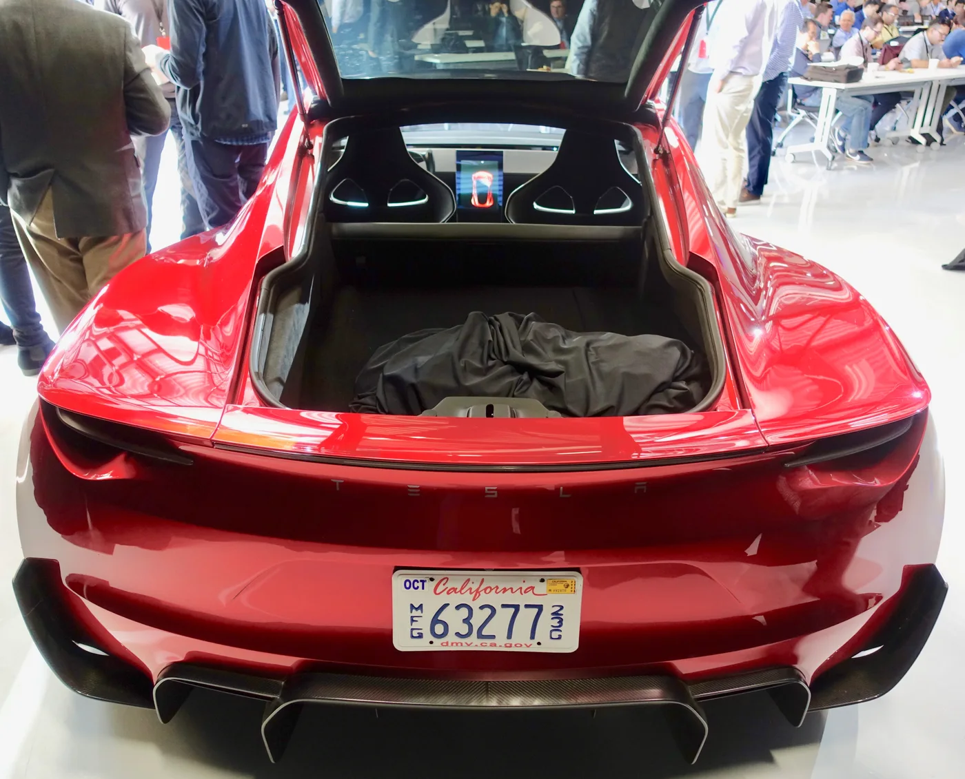 Rear view of the red earlier Roadster prototype with its hatch open in April 2019