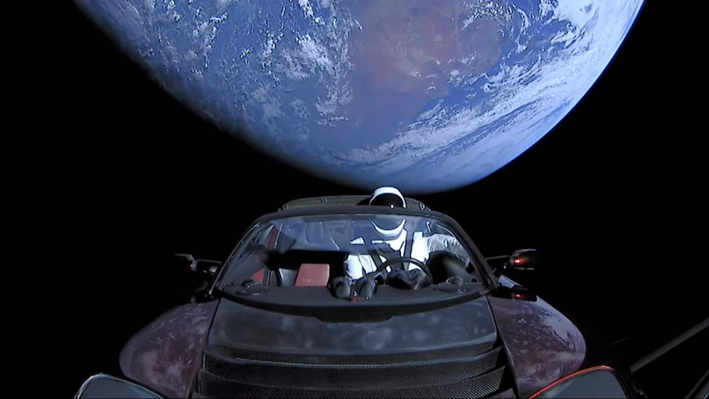 Starman mannequin seated in a Roadster with Earth behind it during the 2018 Falcon Heavy mission